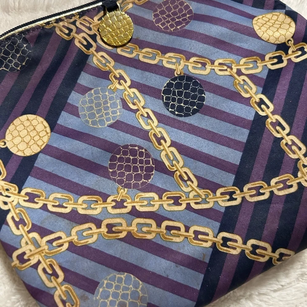 Estée Lauder purple, blue, and gold chain-print cosmetic bag.